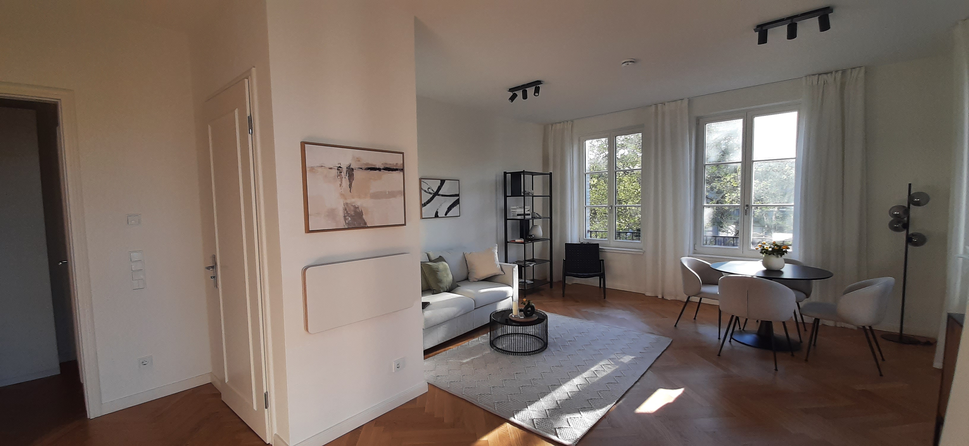 Bright living room with designer furniture and balcony access